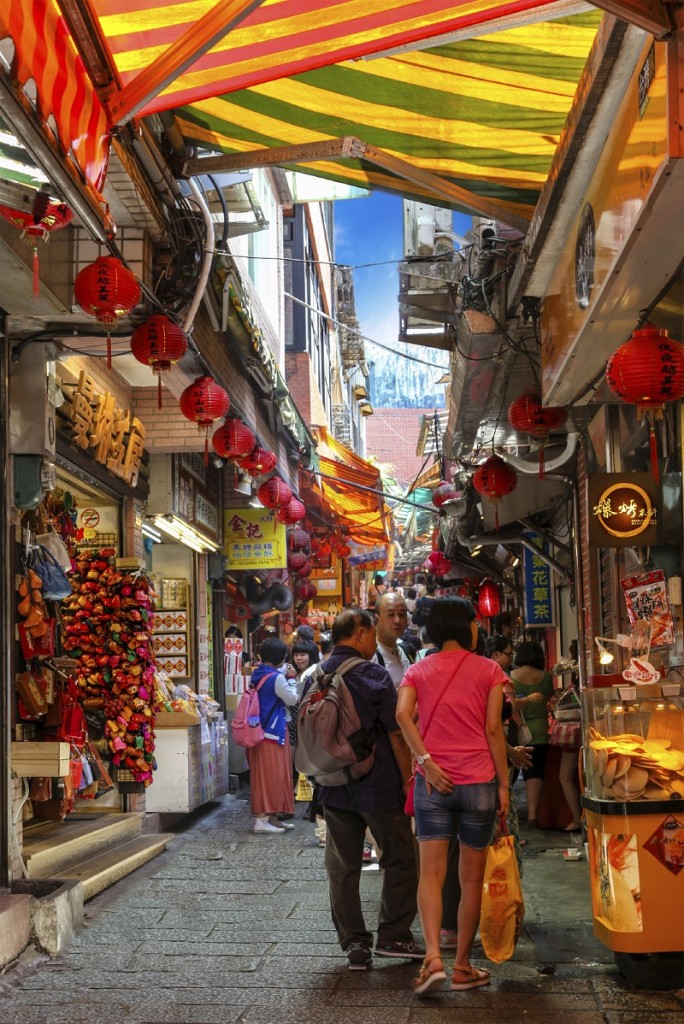 JIUFEN, TAIWAN - JULY 14: Shoppers and tourists stroll along Jiufen old street alley in Taiwan July 14, 2013. Previously a gold-mining town, Jiufen has now become a popular tourist haunt for its nostalgic scenery.