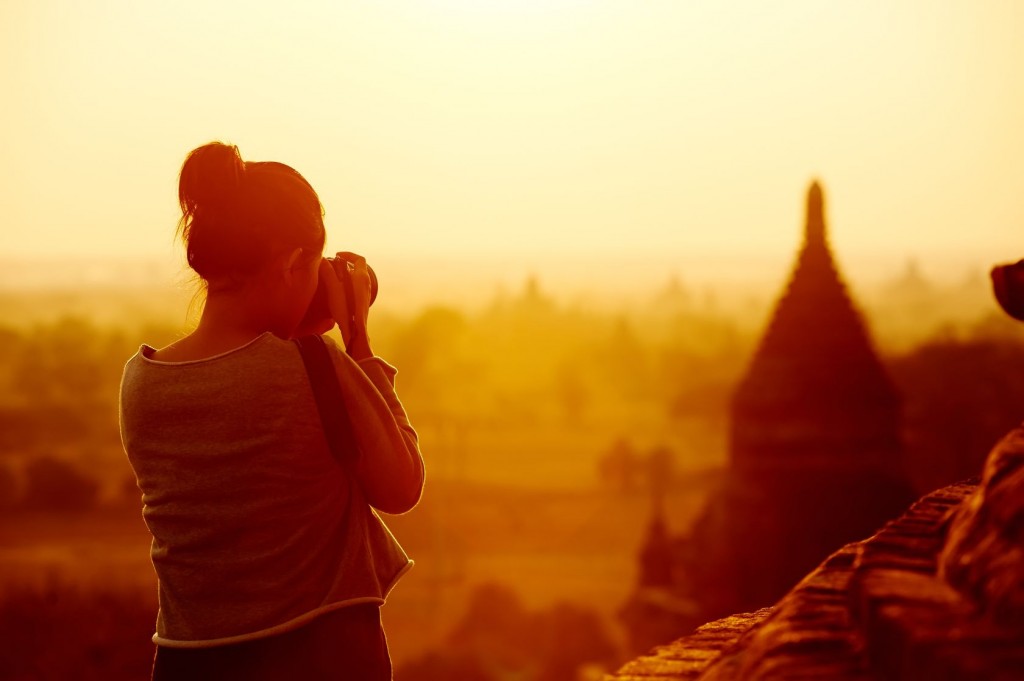 Woman taking a picture and exploring while living abroad