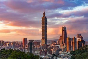 Taipei 101 towers above the skyline as sun sets in Taiwan.