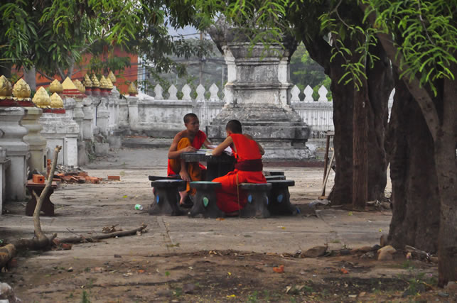 two monks speaking in Laos